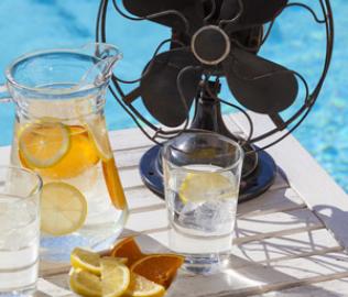 EP Tile - Beat the Heat - Fan, and water jug and glass on the table by the pool