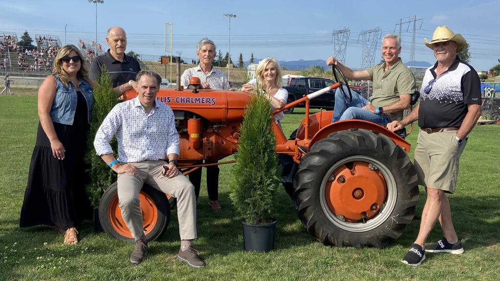 Council gathered around a tractor at Agrifair.