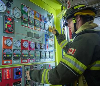 Firefighter working on truck controls
