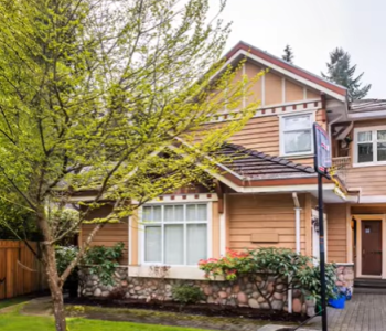 house with a tree in the front yard