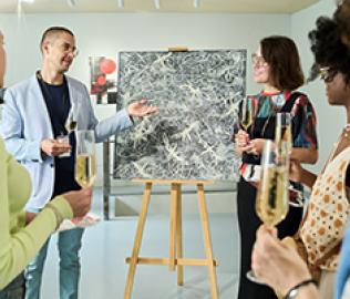 people standing looking at art