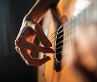 hands stumming guitar