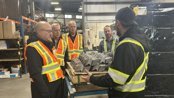 Supervisor Brad Gage and Plant Manager Adam Stephenson talk about welding, including robotic welding, with Councillor Loewen and Mayor Siemens.