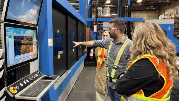 Engineering Manager Cody Bjornsson explains Laser cutting to Councillors Driessen and Ross.