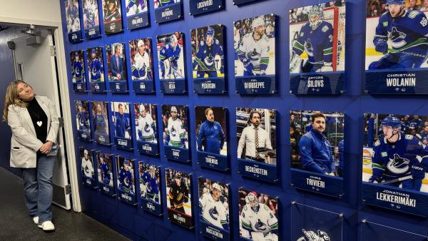 Councillor Driessen checks out “The Highway 1” wall near the players’ facilities commemorating Abbotsford Canucks players’ and staff members’ first NHL game.