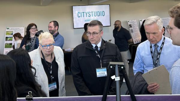 Hubbub judges Mayor Siemens, Abbotsford Fire Rescue Service Chief Erick Peterson, and UFV Information Studies assistant professor Smitty Miller examining one of the displays during CityStudio Hubbub 17.